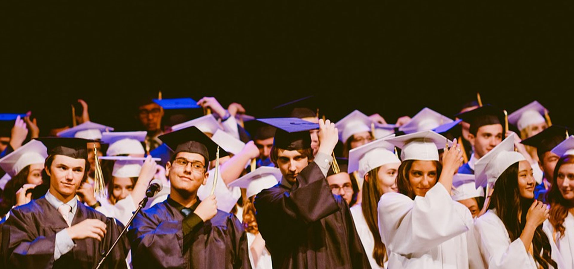 Children graduating and turning tassles